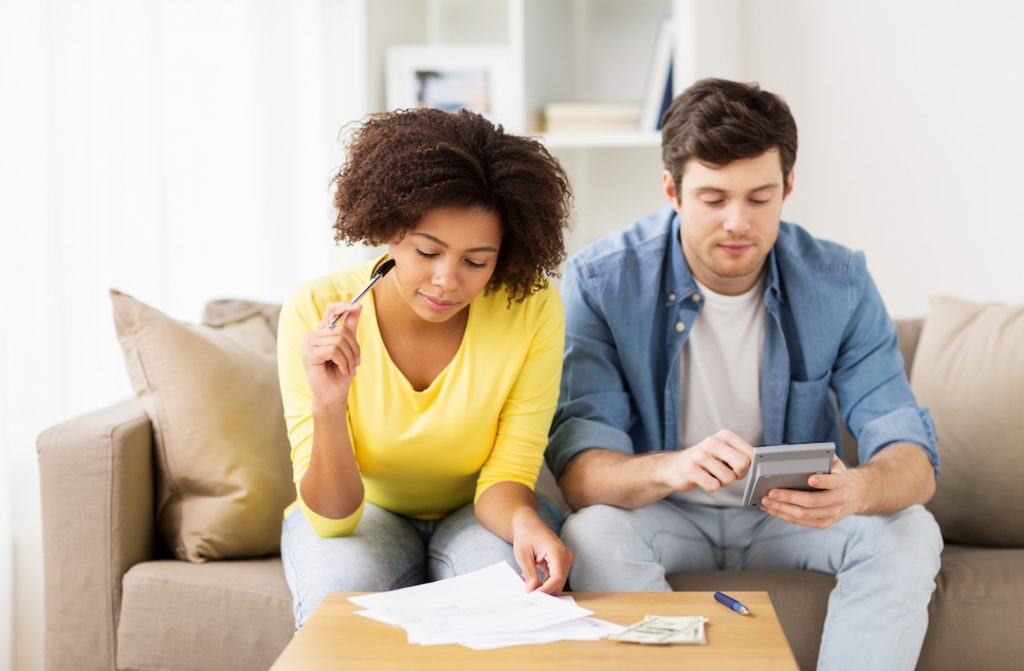 Couple working out finances | Featured image for Budgeting for Your Home Loan: Tracking Your Expenditure blog