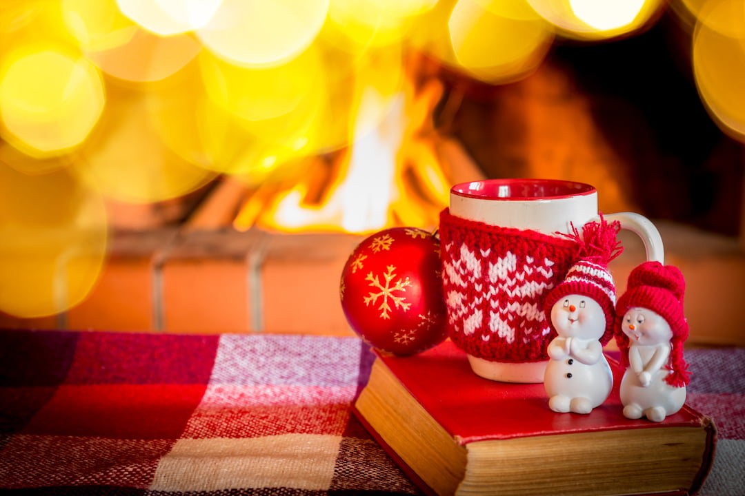 christmas mug infront of lit fireplace | Featured Image For Cash Rate Remains on Hold for Christmas blog